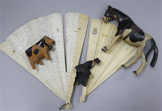A 19th century Chinese ivory brise fan, an Edwardian fan and a carved horse and rider group
